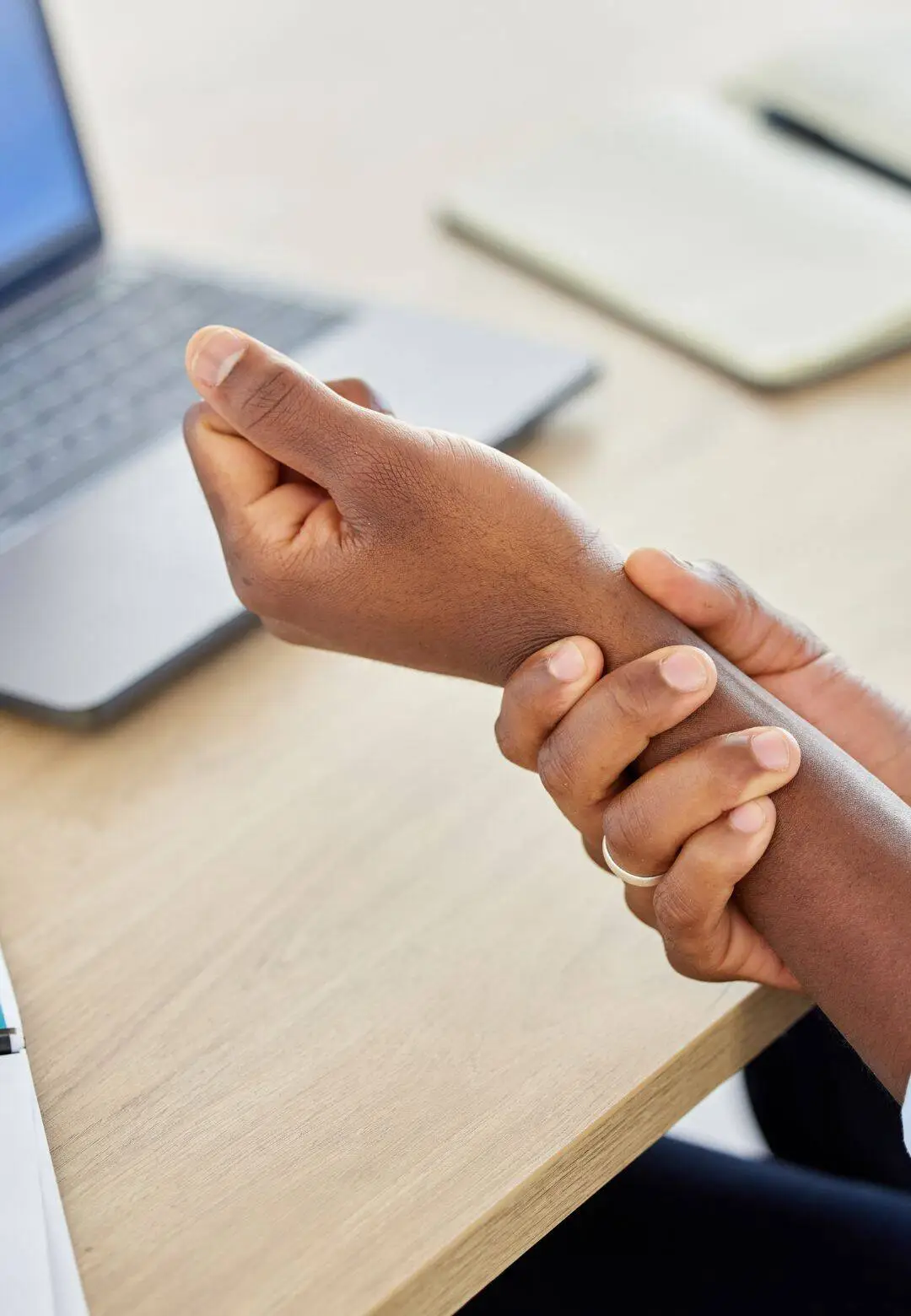 Person holding wrist due to carpal tunnel pain