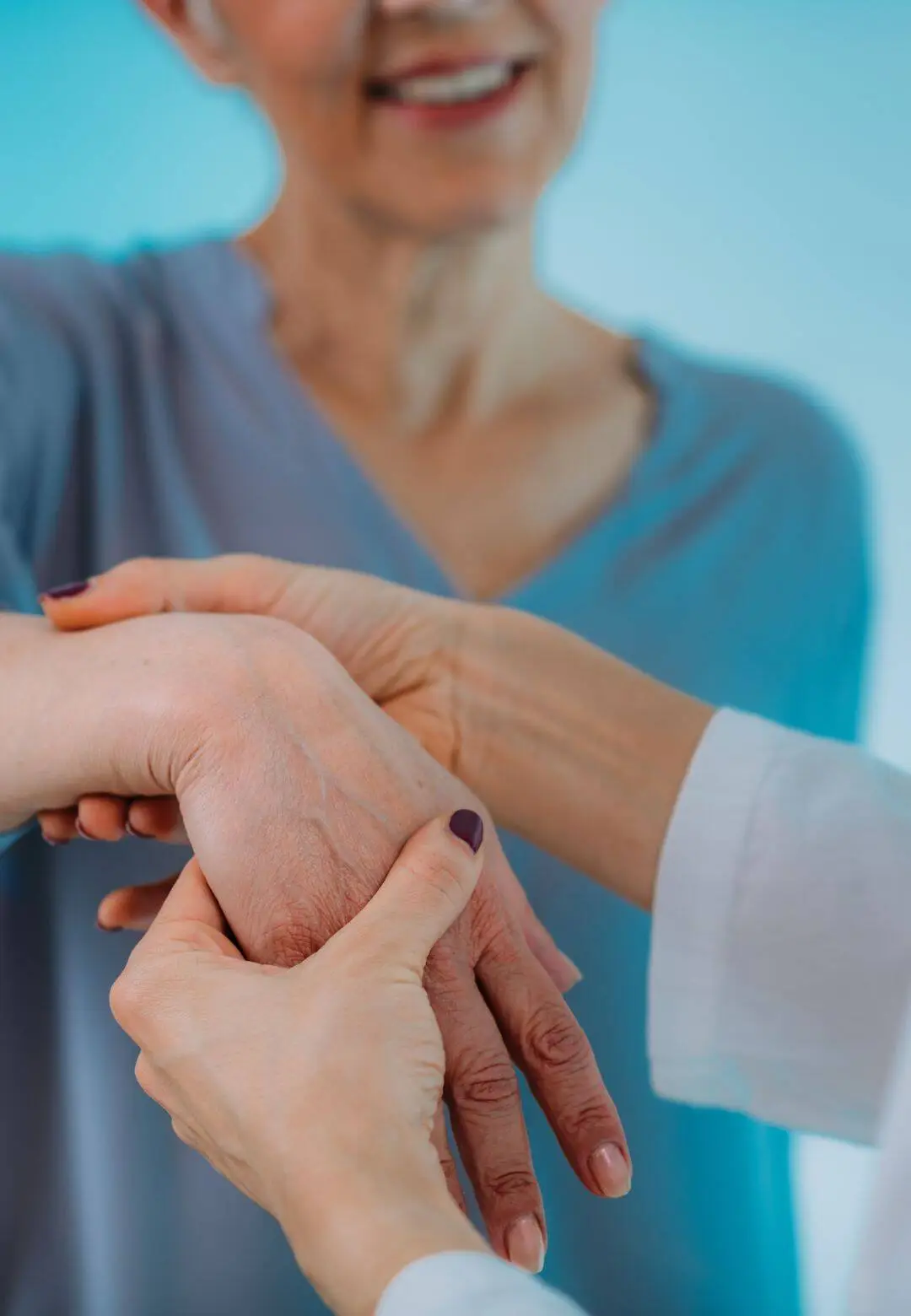 Chiropractor examining patient's hand for carpal tunnel