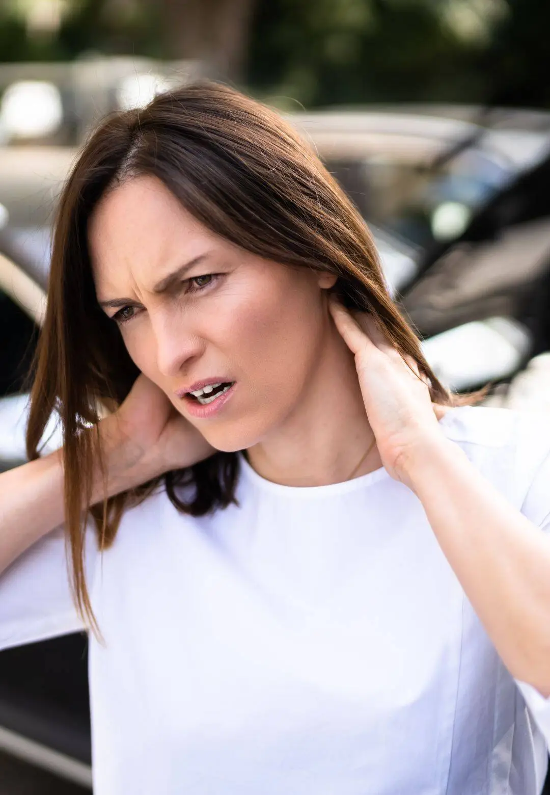 Woman experiencing neck pain from whiplash