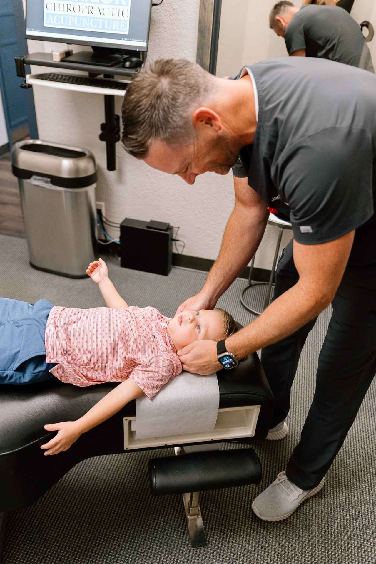 Dr. Meylor providing gentle chiropractic care to a young patient