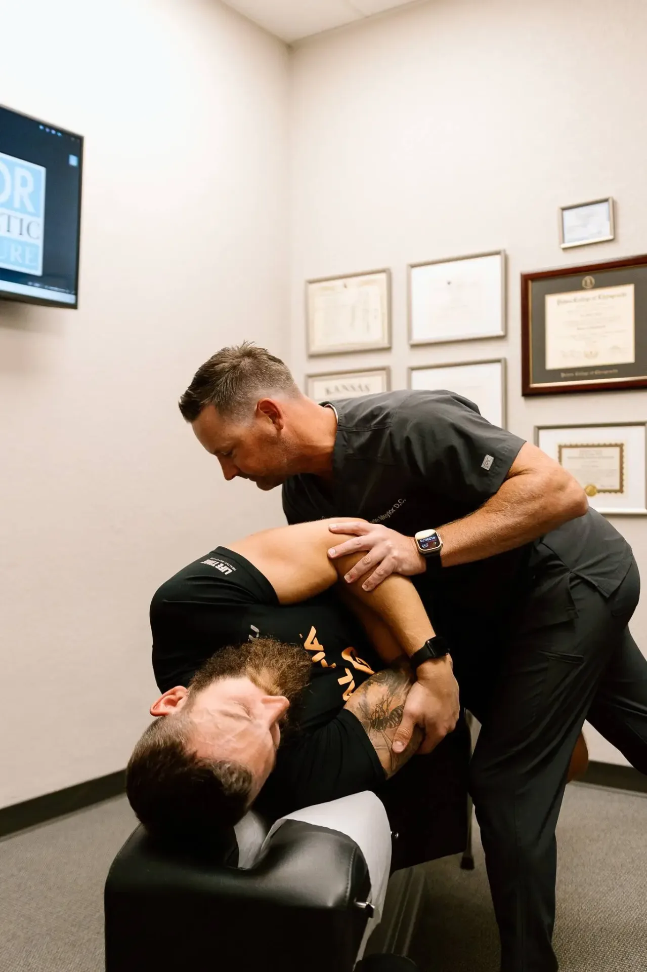 Chiropractor providing treatment for arm pain