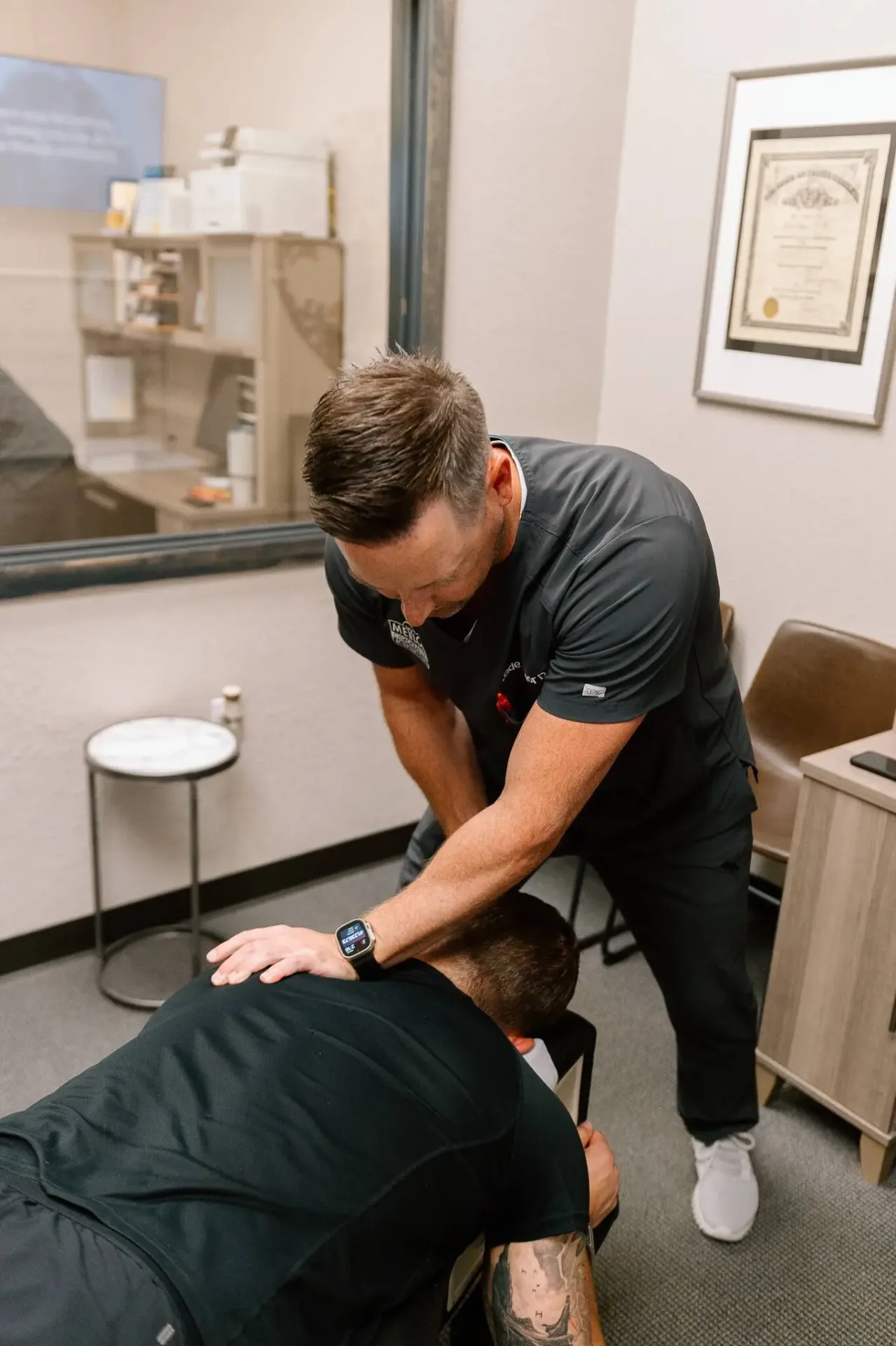 Chiropractor treating patient with arm and leg pain