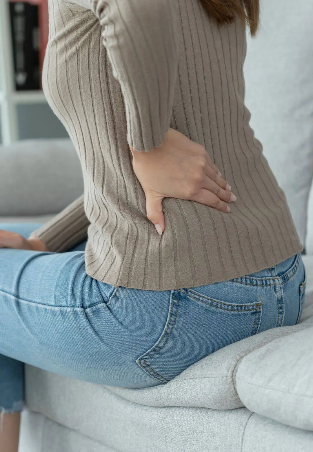 Lenexa patient experiencing chronic back pain seeking chiropractic relief treatment